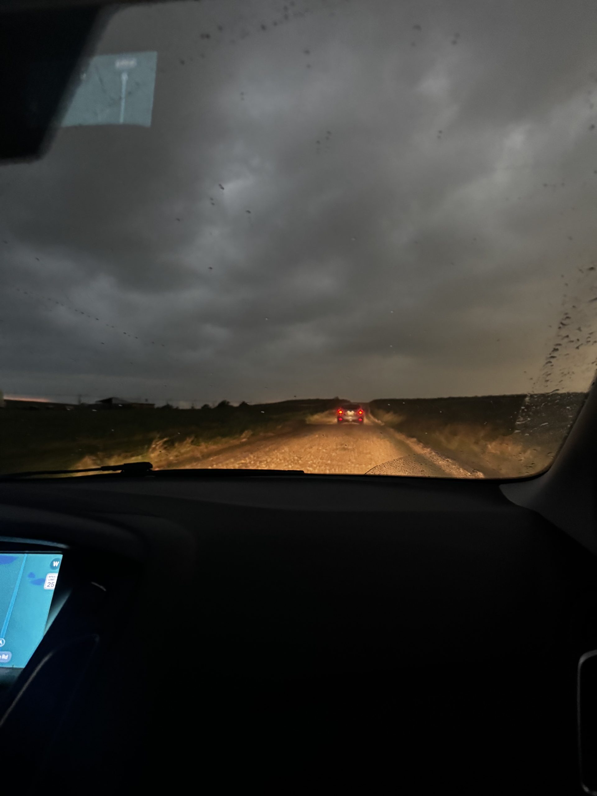 Car in rain at dusk